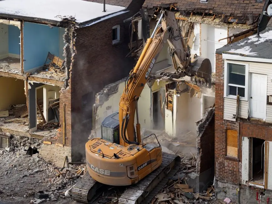 Machinery positioned for home demolition