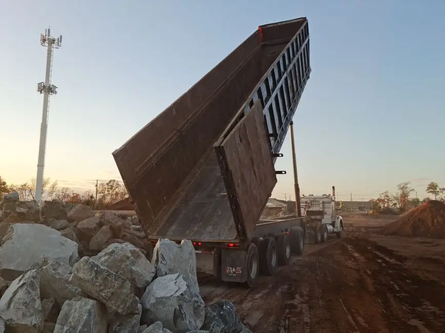 Machinery positioned for waste hauling & disposal